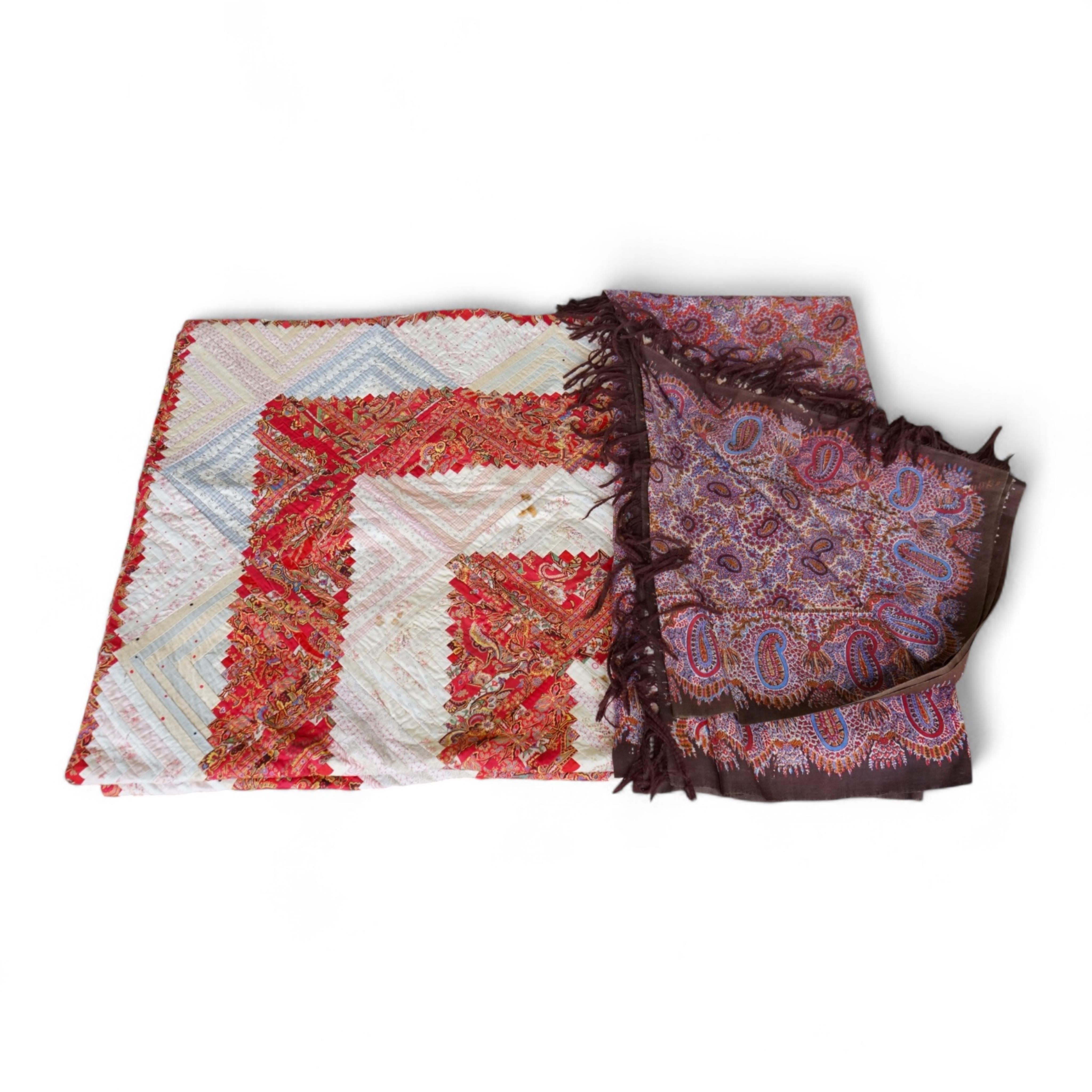 A 19th century printed Paisley summer shawl and an American ‘Log’ patterned patch worked table cover. Cover 152cm x 154cm., Condition - the patchwork has stains and two small holes on the front. The Paisley shawl has a l